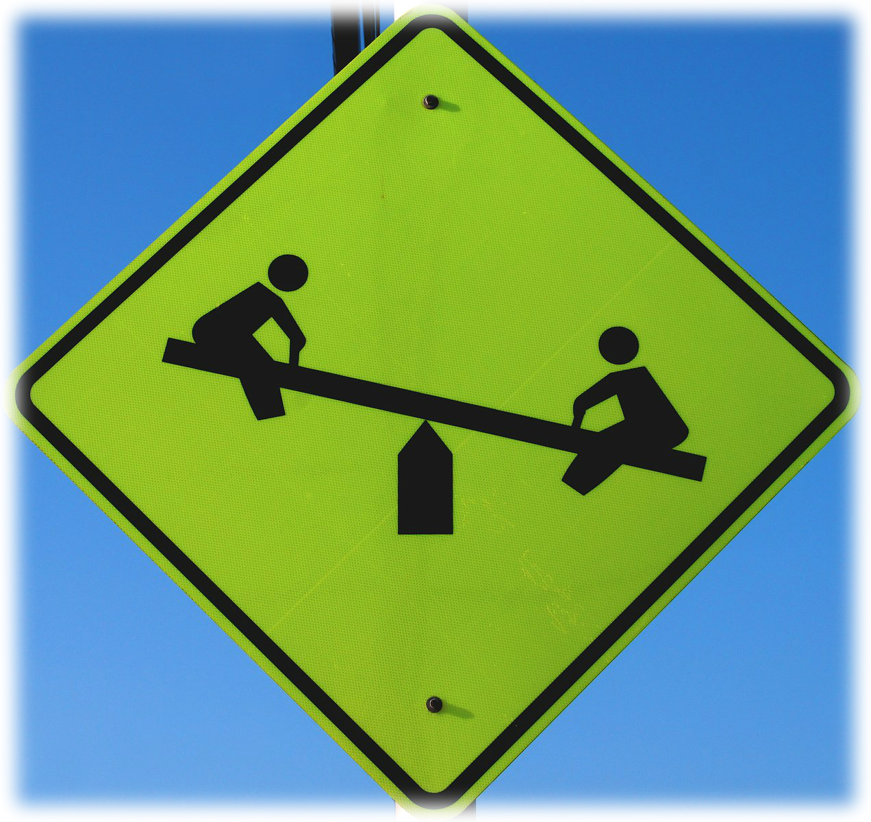 Sign with children on a see-saw